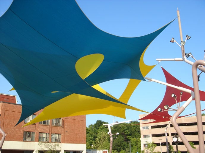 Duvall designed the three-layered fabric structures, freestanding 50-foot curvilinear poles and branched lighting system for this urban waterfront park in Auburn, ME. Design: Charles Duvall.