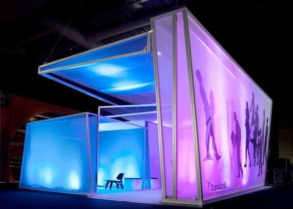 This Transformit exhibit consists of the Louise Room, the Ray Room, and the Julia Room with a giant Piet Wall and custom awning over the entire space. Internal lighting glows on the sheer fabric layers.